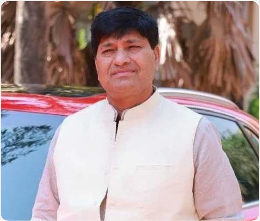 Head-and-shoulders portrait of Rajendra Singh Yadav, chairman, wearing a dark suit and tie and smiling; plain light background; printed text reads Chairman and Chaudhari Attarsingh Yadav Memorial Education Trust, Pune; overall warm and welcoming tone